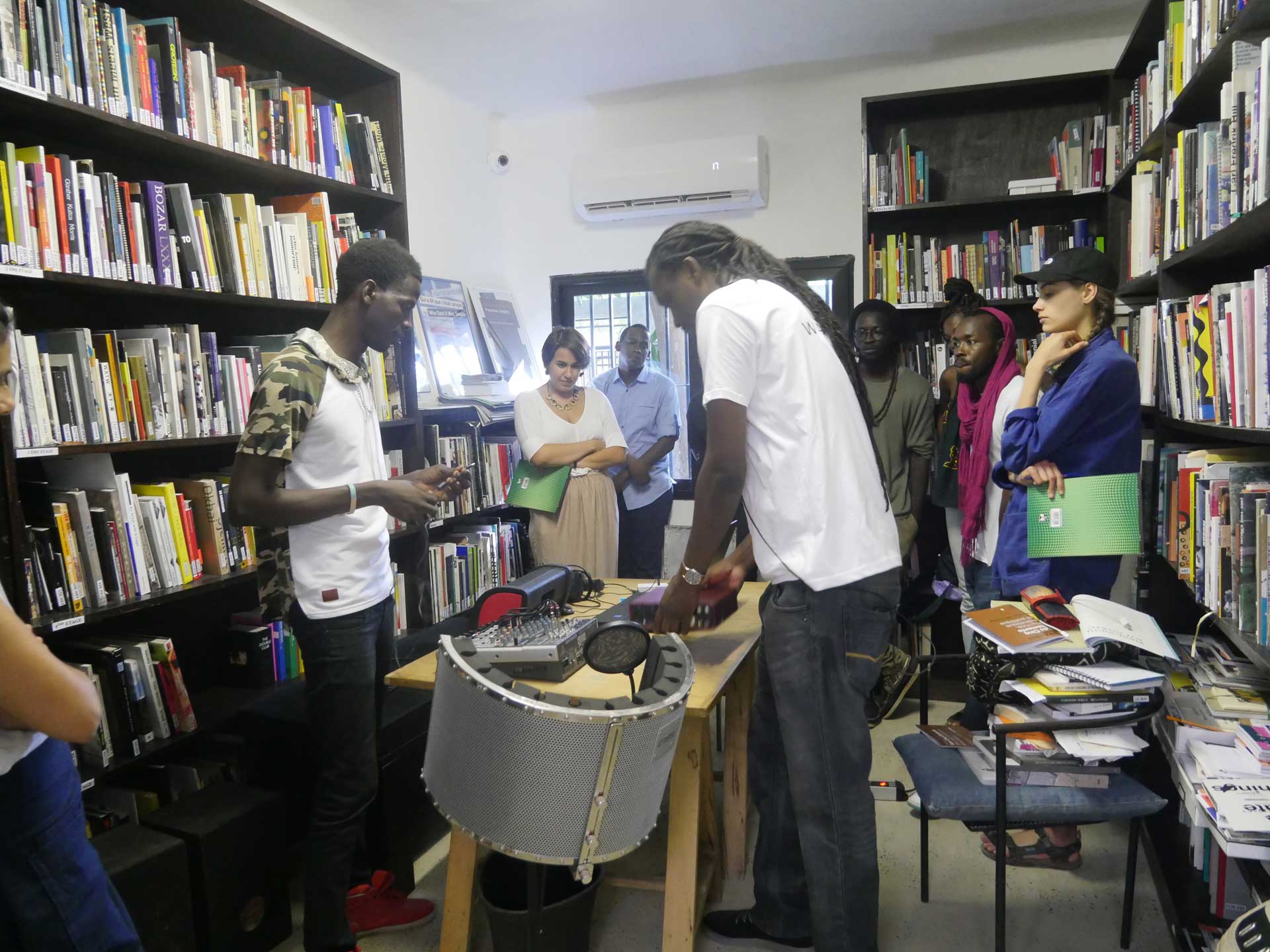 People standing in a library with sound equipment