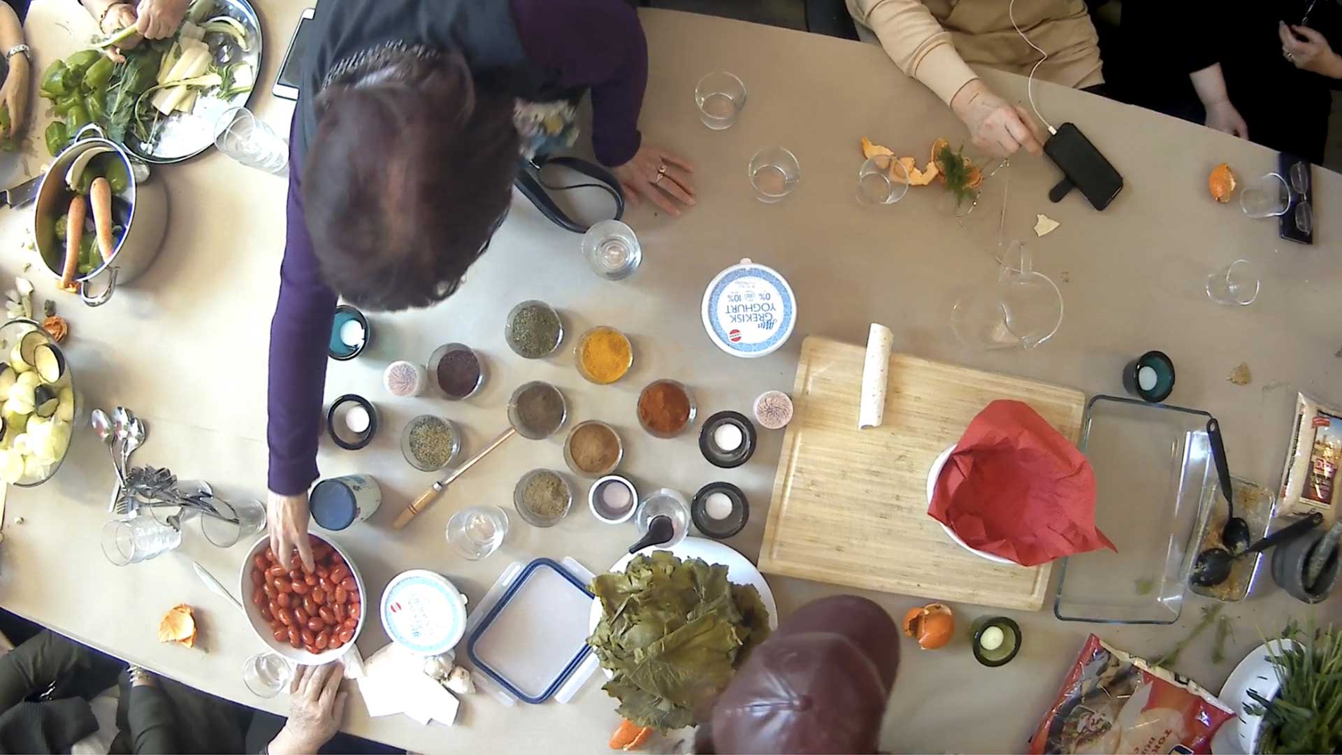 Top view photo of a table with people preparing food