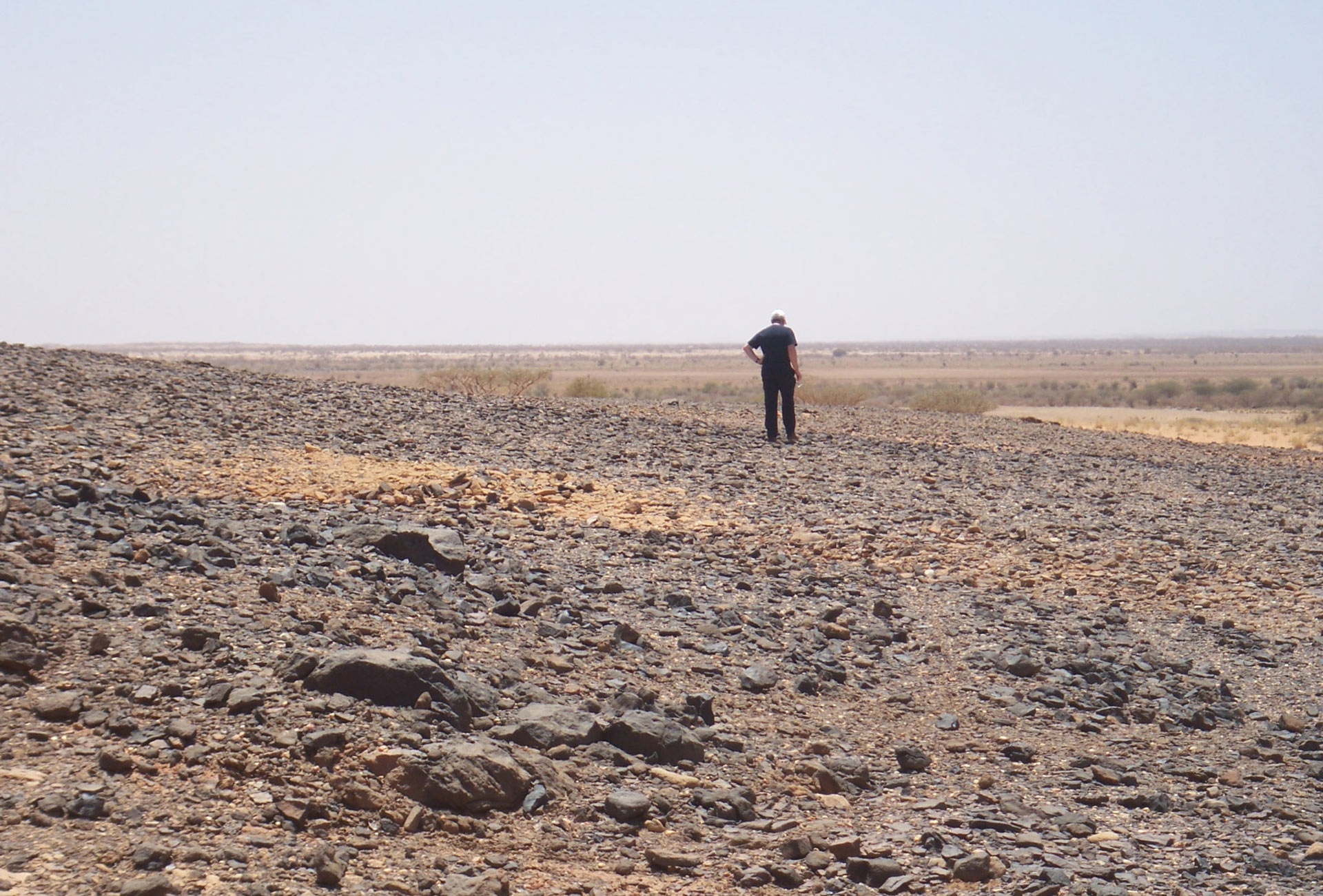 Man walking in the distance in the desert